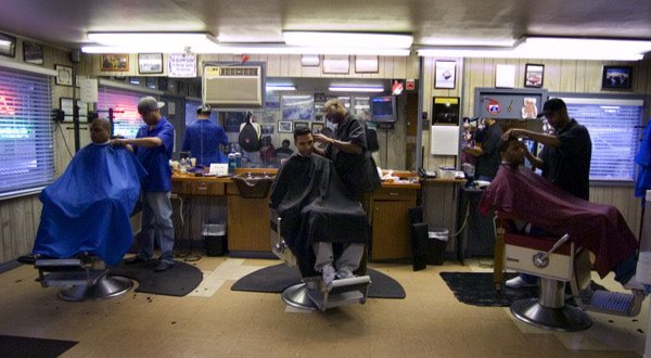 Barbers at work inside Larry’s shop